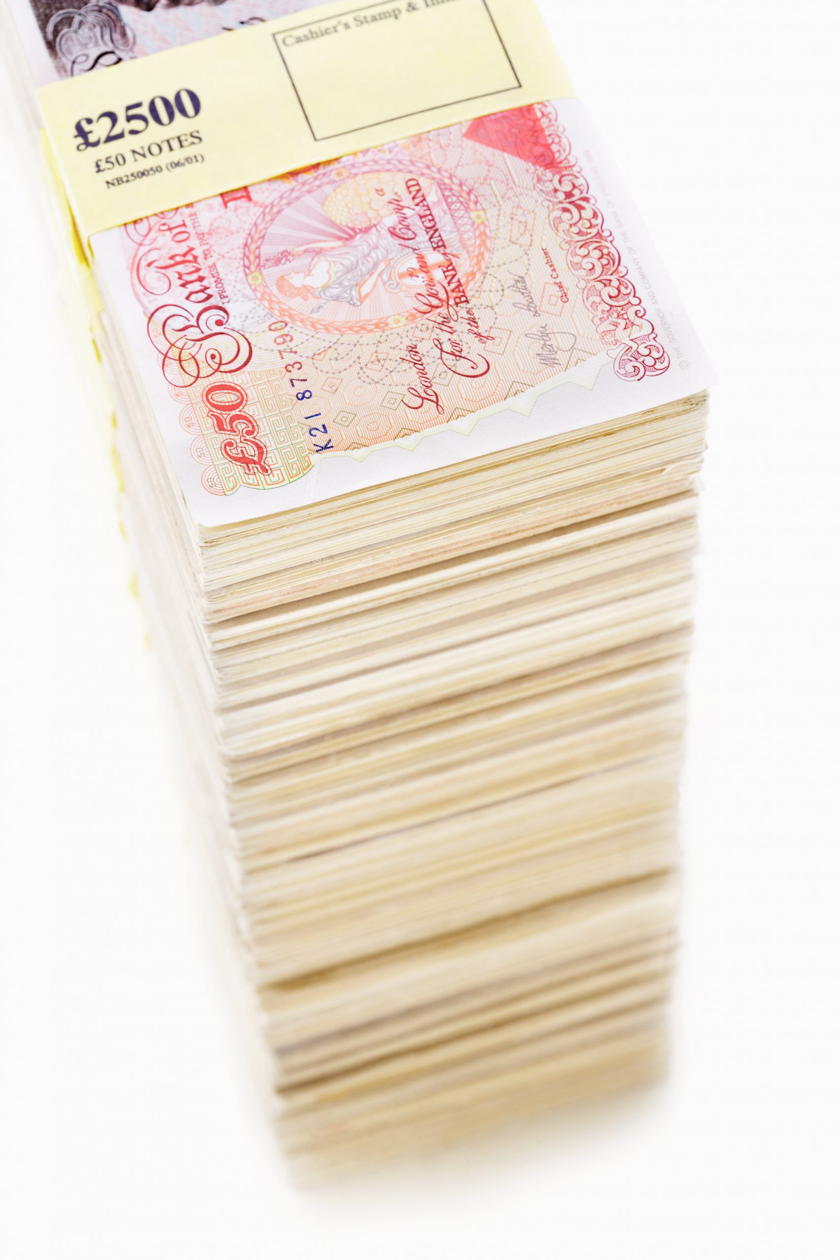 Pile of pound banknotes with seal on white background